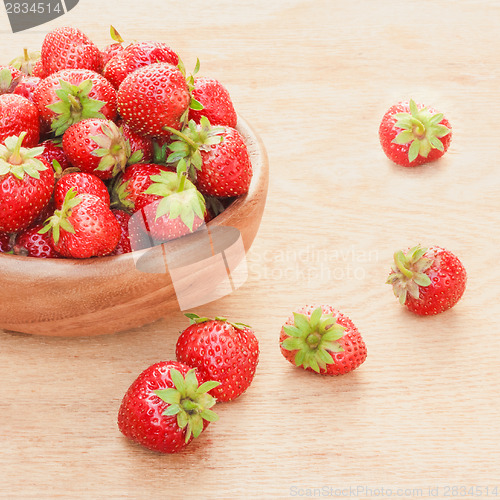 Image of Close-Up Of Strawberries In Vintage Wooden Bowl On Table