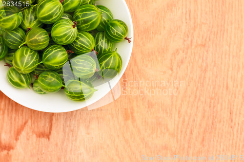 Image of Close-Up Of Gooseberries In Vintage White Dish On Wooden Table