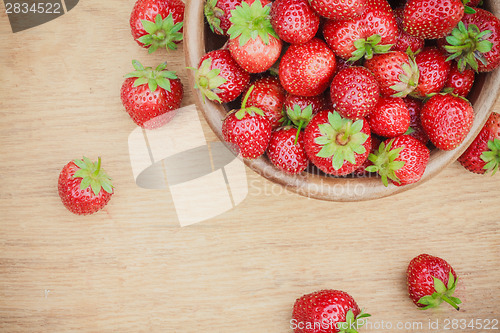 Image of Close-Up Of Strawberries In Vintage Wooden Bowl On Table