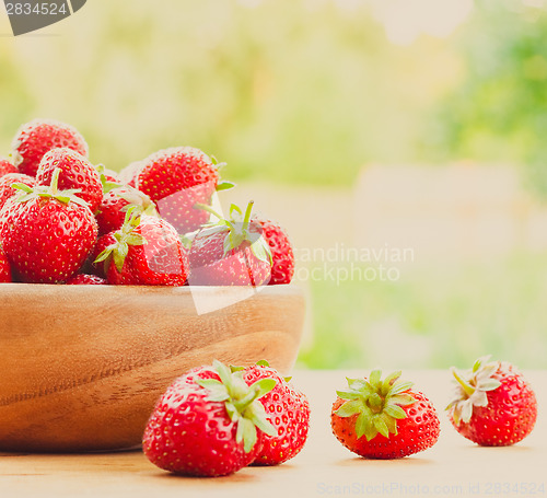 Image of Close-Up Of Strawberries In Vintage Wooden Bowl On Table