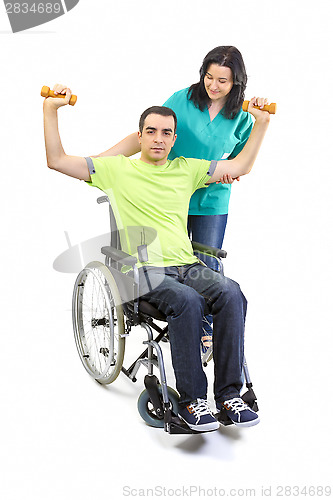 Image of Therapist assists patient with weightlifting