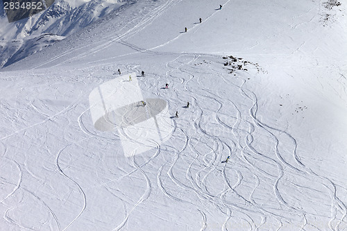 Image of Snowboarder downhill on off piste slope with newly-fallen snow