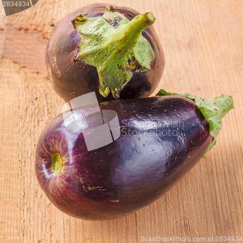 Image of Eggplants On A Wooden Background