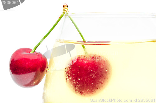 Image of Pair of ripe cherry berries on wineglass