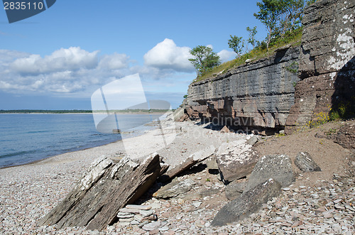 Image of Cliffs by the coast at a calm bay