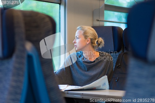 Image of Lady traveling by train.