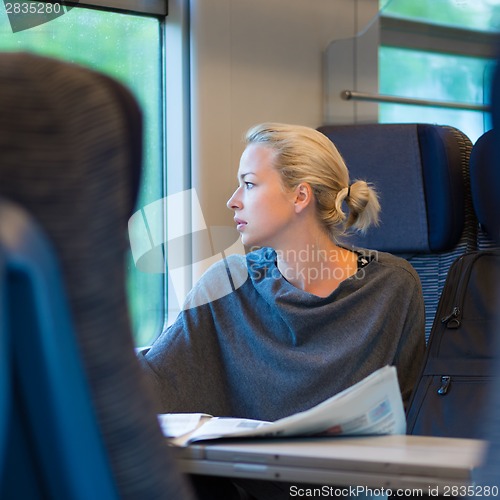 Image of Lady traveling by train.