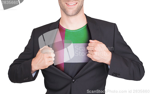 Image of Businessman opening suit to reveal shirt with flag