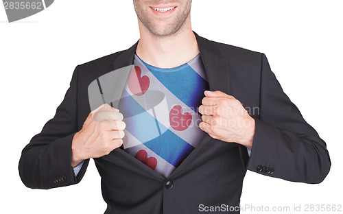 Image of Businessman opening suit to reveal shirt with flag