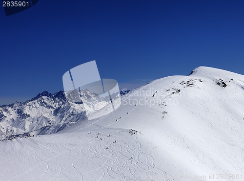 Image of Snowboarders and skiers downhill on off piste slope