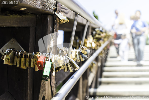 Image of Padlocks of lovers placed on the bridge