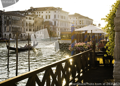 Image of Ancient buildings and boats in the channel in Venice.