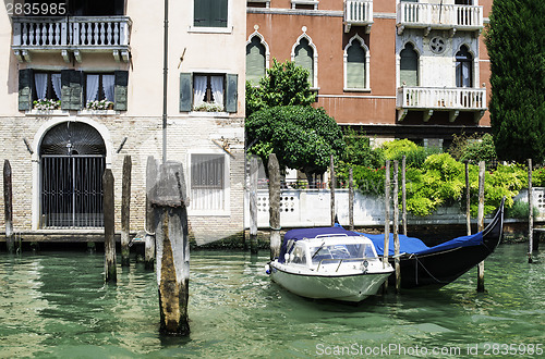 Image of Ancient buildings and boats in the channel in Venice