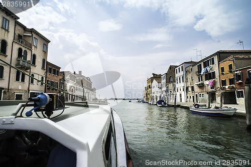 Image of Ancient buildings and boats in the channel in Venice