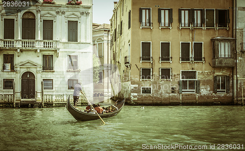 Image of Ancient buildings in Venice. Boats moored in the channel. Gondol
