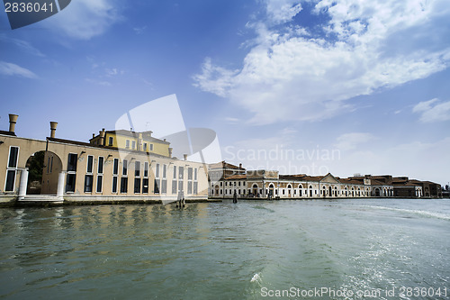 Image of Ancient buildings in Venice. Boats moored in the channel