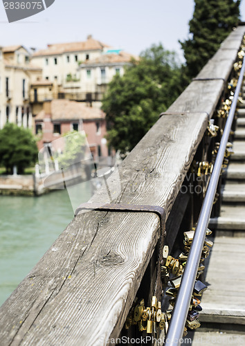 Image of Padlocks of lovers placed on the bridge