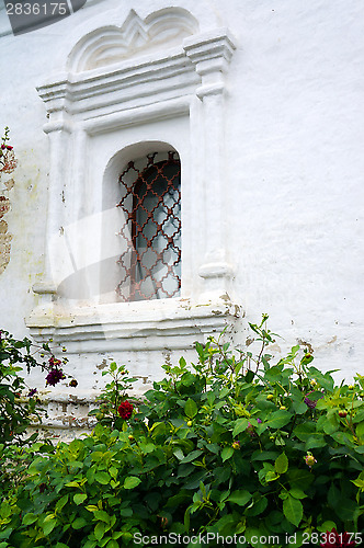 Image of Barred window - Detail of an old white church