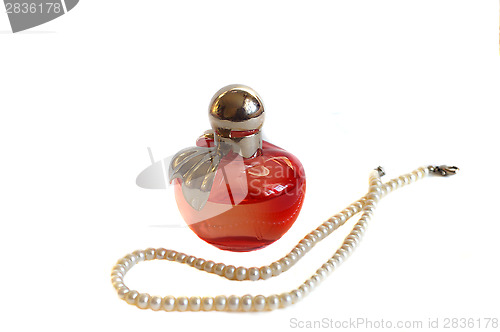 Image of Perfume bottle and pearl beads isolated on white