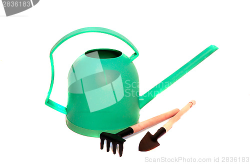 Image of Green watering can, shovel and rake care of houseplants