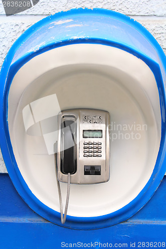 Image of Blue pay-phone on wall