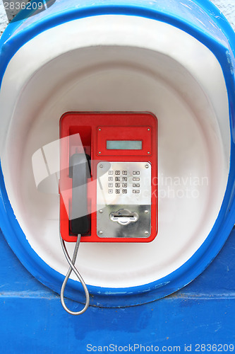 Image of Red pay-phone on wall