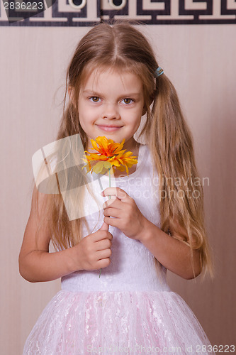 Image of Girl in white dress with a flower