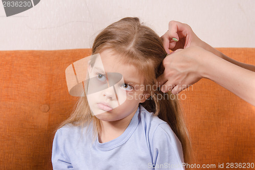 Image of Mom upset girl hair braids