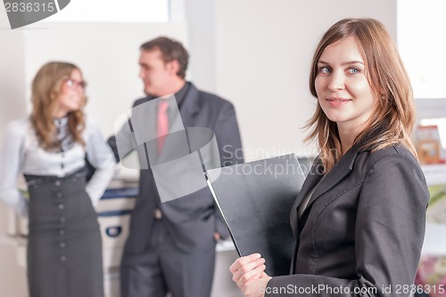 Image of Smiling young woman in office
