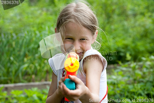 Image of small girl with toy water gun