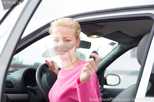 Image of Woman driver showing car keys.