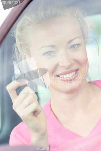 Image of Woman driver showing car keys.