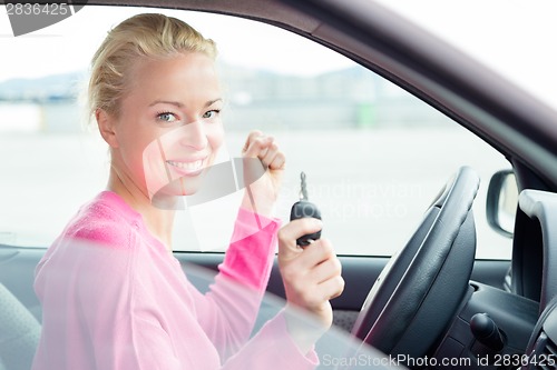 Image of Woman driver showing car keys.