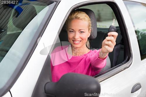 Image of Woman driver showing car keys.