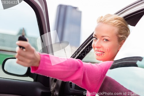 Image of Woman driver showing car keys.