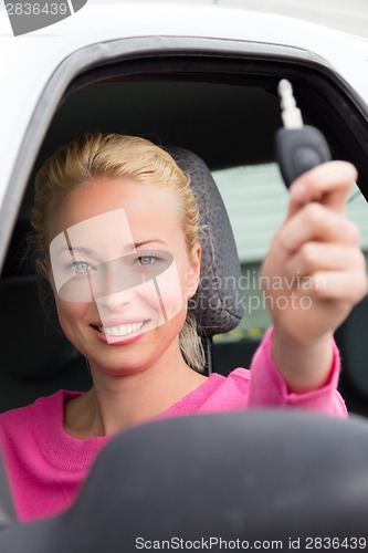 Image of Woman driver showing car keys.