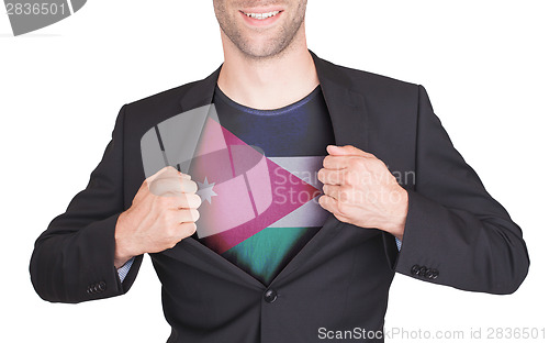 Image of Businessman opening suit to reveal shirt with flag