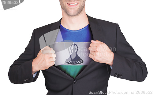 Image of Businessman opening suit to reveal shirt with flag