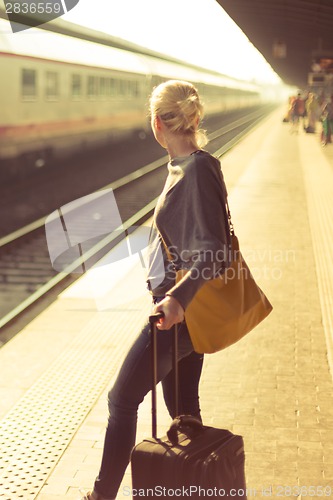 Image of Lady waiting at the railway station.