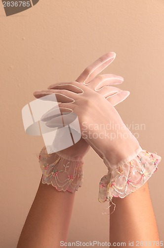 Image of female hands modeling vintage lace gloves