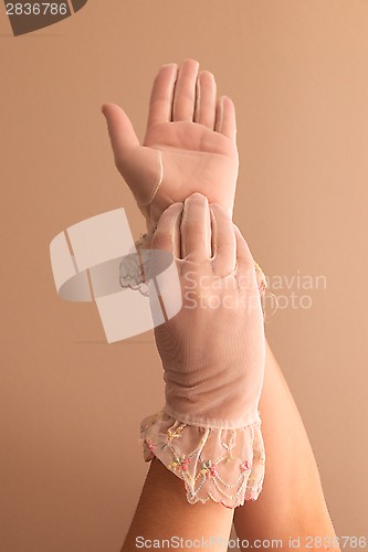 Image of female hands modeling vintage see through gloves