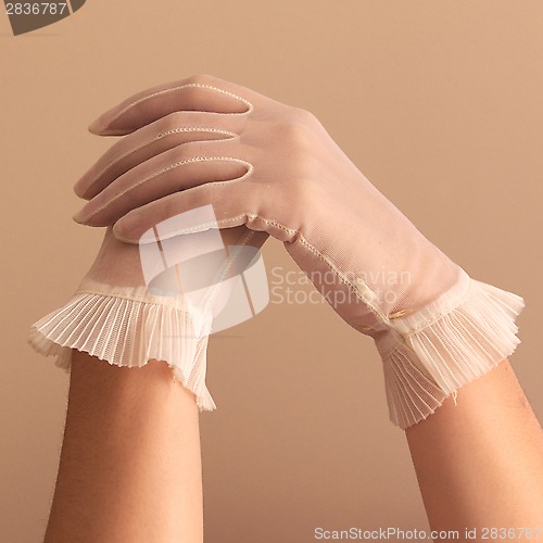 Image of female hands modeling vintage sheer gloves