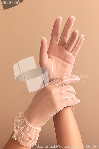 Image of womans hands modeling vintage lace gloves