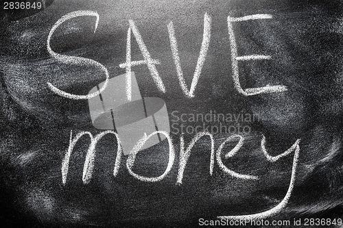 Image of Handwritten message on chalkboard writing message Save Money