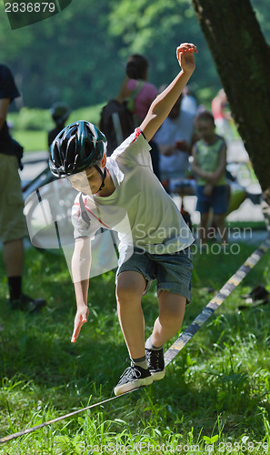 Image of Little boy balancing on a tightrope