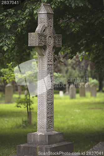 Image of A Concrete Celtic Cross in a Graveyard