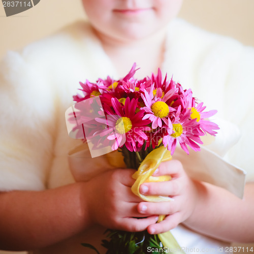 Image of Little Girl With Pink Flowers Asters In Their Hands