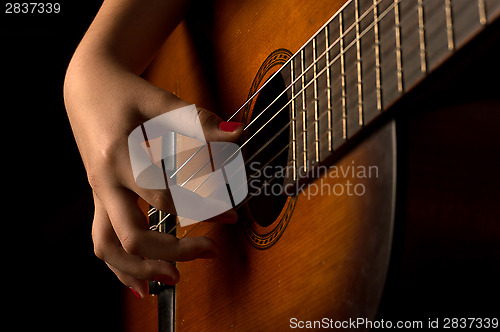 Image of Girl playing a guitar