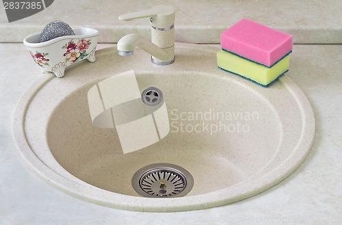 Image of Sink for ware from metal ceramics and a sponge for washing.