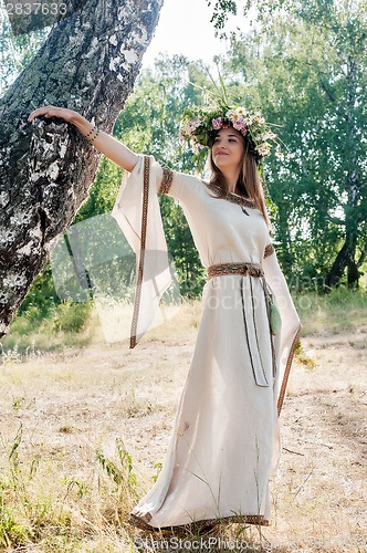 Image of Beatiful woman in national dress and flower wreath